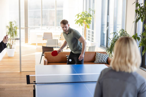 Two player playing table tennis in offce stock photo