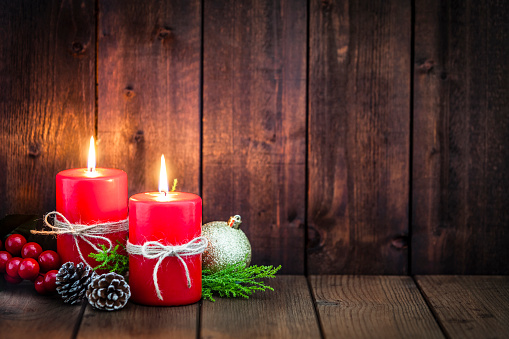Two Red Christmas Candles On Rustic Table With Copy Space Stock Photo -  Download Image Now - iStock