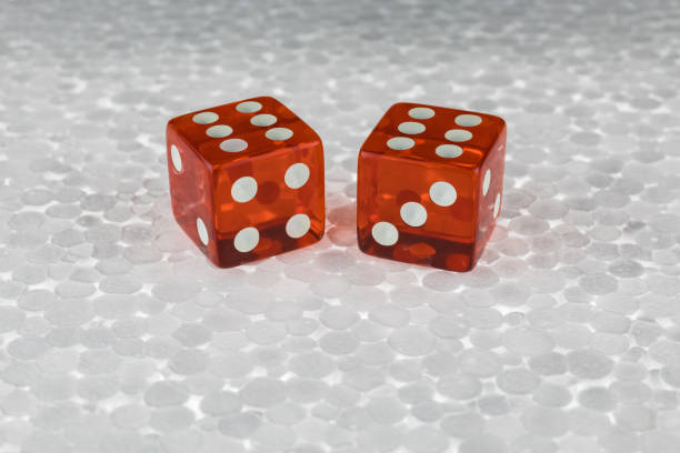 Two red transparent dice on a foam board. The result is "six" and "six". Two red transparent dice on a foam board. The result is "six" and "six". Macro photography. Business and finance. foamcore stock pictures, royalty-free photos & images