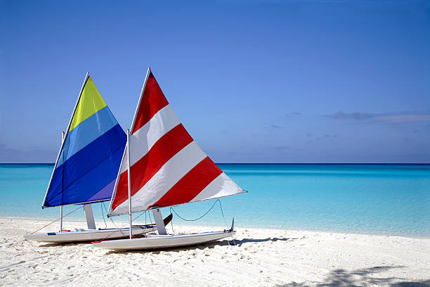 Two sailboats on the beach near the shore stock photo