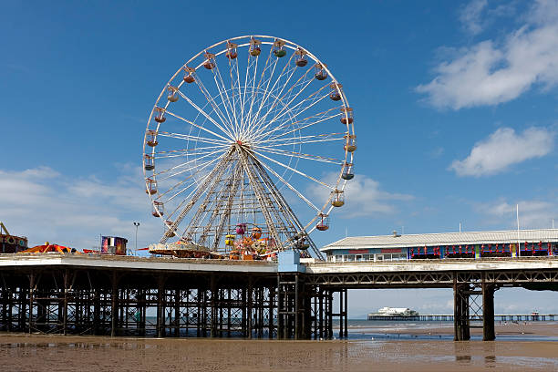 Two seaside piers, Blackpool Traditional Victorian seaside piers. The Central Pier with fairground rides is in the foreground, with the North Pier behind, in the seaside town of Blackpool, Lancashire, UK.  north pier stock pictures, royalty-free photos & images