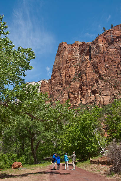 Senior Couples Pause Along the Riverwalk Trail Zion National Park, Utah, USA - May 10, 2011: Two senior couples pause to talk while hiking on the Riverwalk Trail near the Temple of Sinewava. jeff goulden zion national park stock pictures, royalty-free photos & images