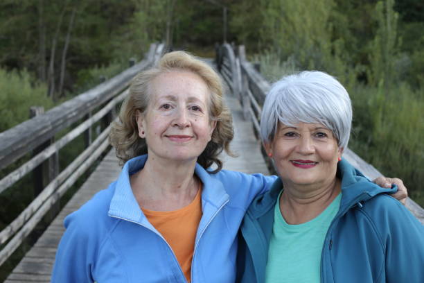 Two senior female friends in nature stock photo