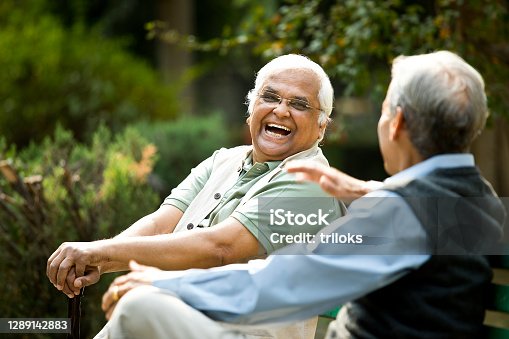 istock Two senior men discussing on park bench 1289142883