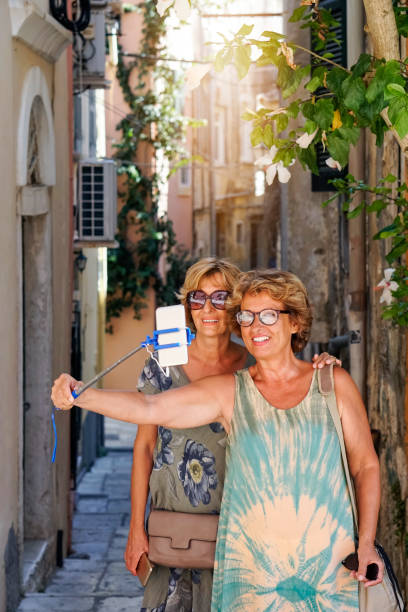 Two Senior women exploring the Corfu town stock photo