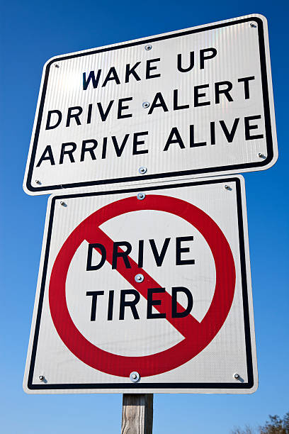 Two signs to warn drivers to not drive while tired stock photo