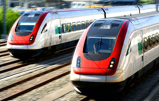 Two silver and red trains head to head stock photo