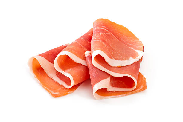Two slices of prosciutto on a white background Prosciutto Slices on White Background delicatessen photos stock pictures, royalty-free photos & images