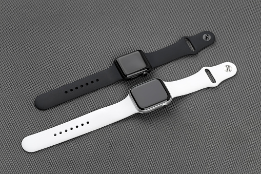 Two smart watches Apple Watch on a gray background.