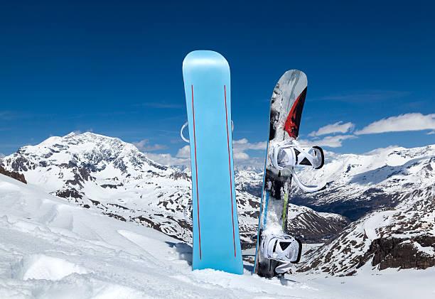 Two snowboard standing upright in snow stock photo