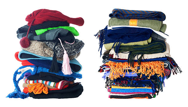 Two stacks of winter hats and scarfs | Isolated stock photo