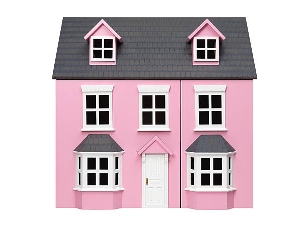 Two story pink model play house with white trim and door pink toy house on white model house stock pictures, royalty-free photos & images
