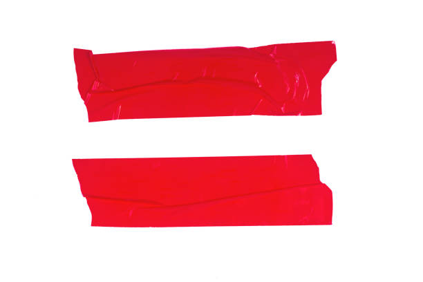 Two strips of red adhesive tape isolated on a white background. stock photo