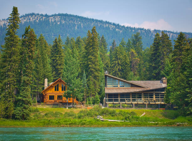Two styles of wooden house commonly found near lakes and rivers. Rocky mountain ( Canadian Rockies ). Portrait, fine art. Near Calgary. Jasper and Banff National Park, Alberta, Canada: August 2, 2018 stock photo