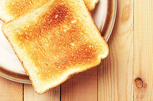 Two toast bread Two toast bread on wooden background closeup toasted food stock pictures, royalty-free photos & images