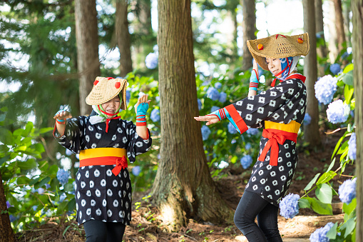 Beautiful Japanese women in traditional festival costume in mountain forest.