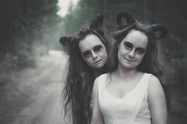 Two twins demons with horns in forest Two twins demons with horns in forest outdoor ugly girl stock pictures, royalty-free photos & images