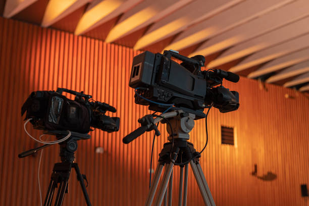 Two video cameras for a live stream or video production at a fancy gala event. Two cameras on tripods at an event. stock photo