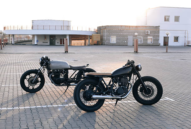 Two vintage custom motorcycles in the parking lot during sunset. Road...