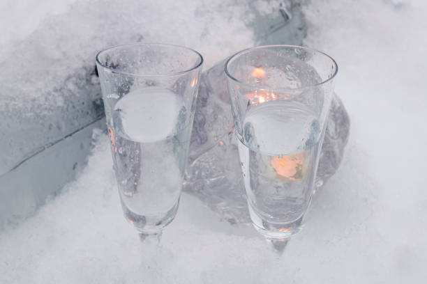 Two vodka shots in snow and ice stock photo