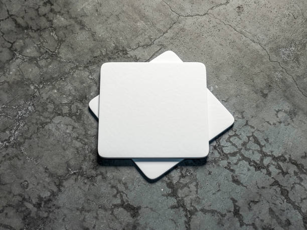 Two White beer coasters Mockup on the concrete floor Two White beer coasters Mockup on the concrete floor. 3d rendering coaster stock pictures, royalty-free photos & images