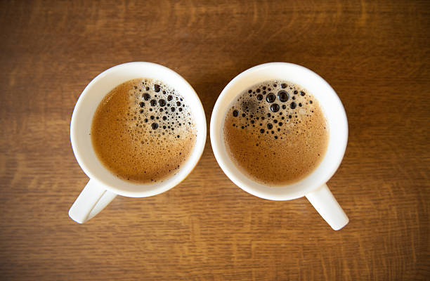 Two whte cups with espresso stock photo
