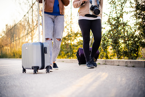 Two woman with suitcase walking together
