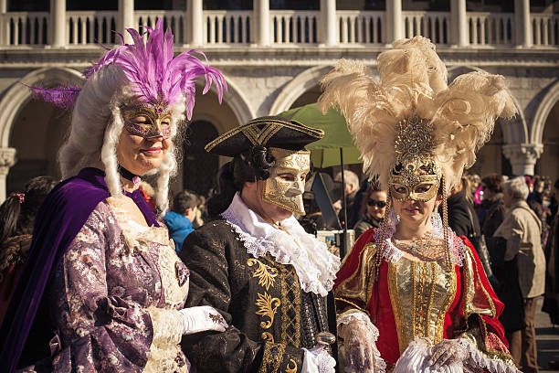 Two Women and One Man Masked at Venice Carnival 2013 stock photo