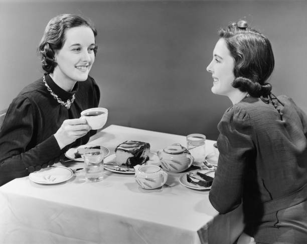 Two women having coffee and cake (B&W)  female friendship photos stock pictures, royalty-free photos & images