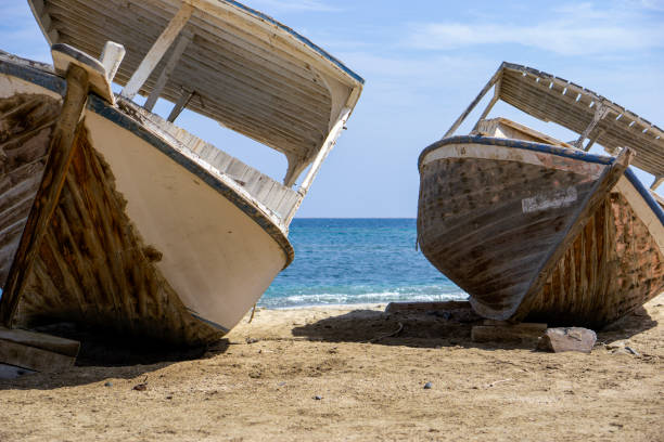 Two wooden and old boats on the shore by the sea. stock photo
