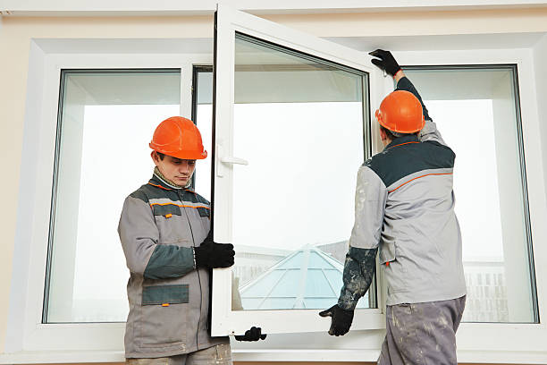 two workers installing window stock photo