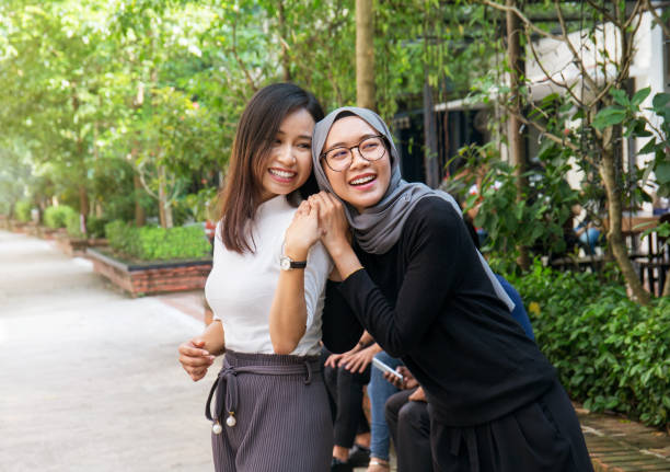 Two young Asian girls having fun outdoors Two young Asian girls having fun outdoors indonesian woman stock pictures, royalty-free photos & images