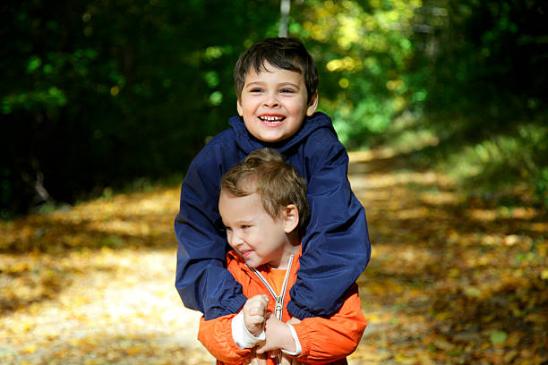 Two young boys have fun outdoors stock photo