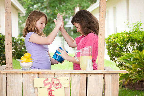 Two young girls high fiving stock photo