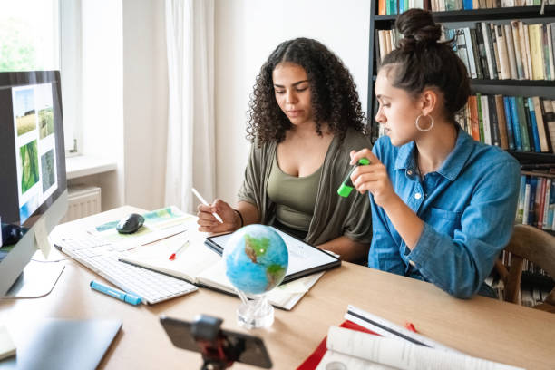two young woman preparing together presentation for climate protection stock photo