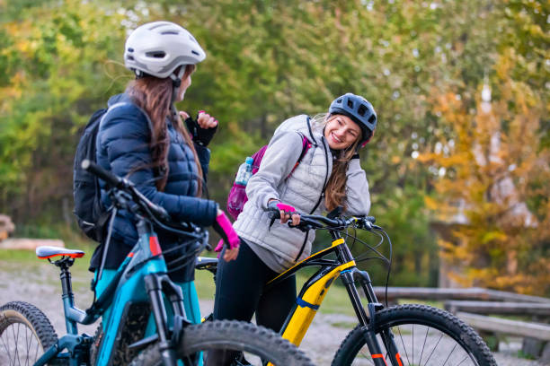 Two young women on a e-bike ride stock photo