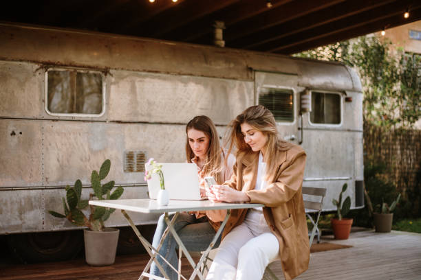 Two young women working outdoors stock photo