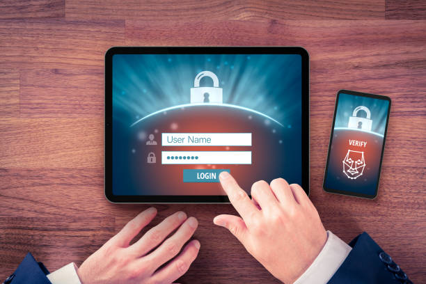 Two-factor authentication (2FA) and face identification Two-factor authentication (2FA) and face identification security concept. User with digital tablet and smart phone and two-factor authentication security process, flatlay design. authenticate stock pictures, royalty-free photos & images