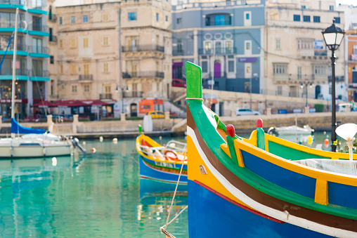Typical colorful painted fishing boats in Malta are anchored
