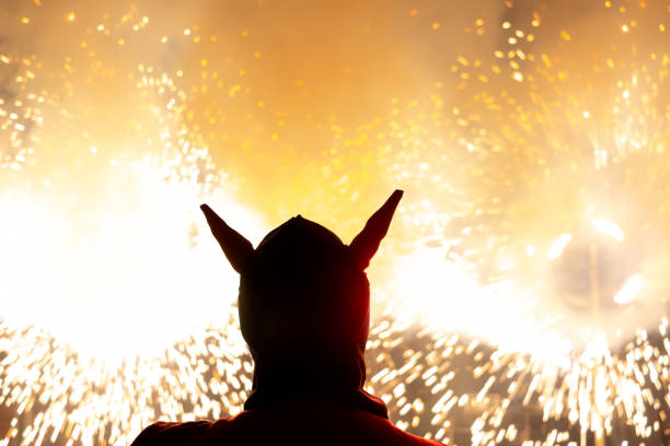 Typical Correfocs in Spain. Silhouette of a demon in a fire show at traditional festival stock photo