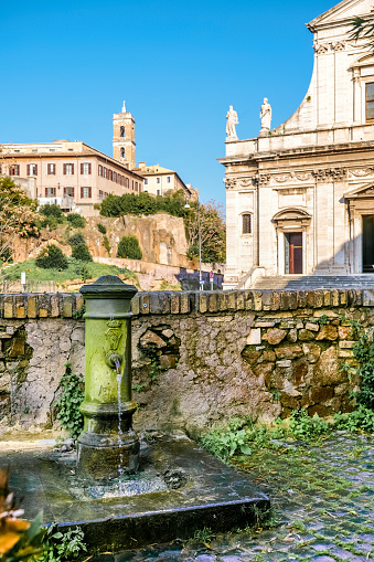 A typical fountain of drinking water of Rome, located in the heart of the city near the Roman Forum. This fountains are known among the Romans as 'nasone' (big nose) due to the shape of its tap. On the background the Capitoline Hill (Campidoglio). Image in High Definition format.