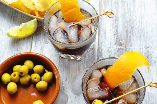 Typical Spanish appetizer with vermouth, olives, fried potatoes with pepper and lemon Typical Spanish appetizer with vermouth, olives, chips with pepper and lemon vermouth stock pictures, royalty-free photos & images