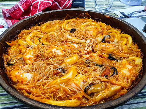 Typical Spanish dish of fideua on a table. Spanish food concept
