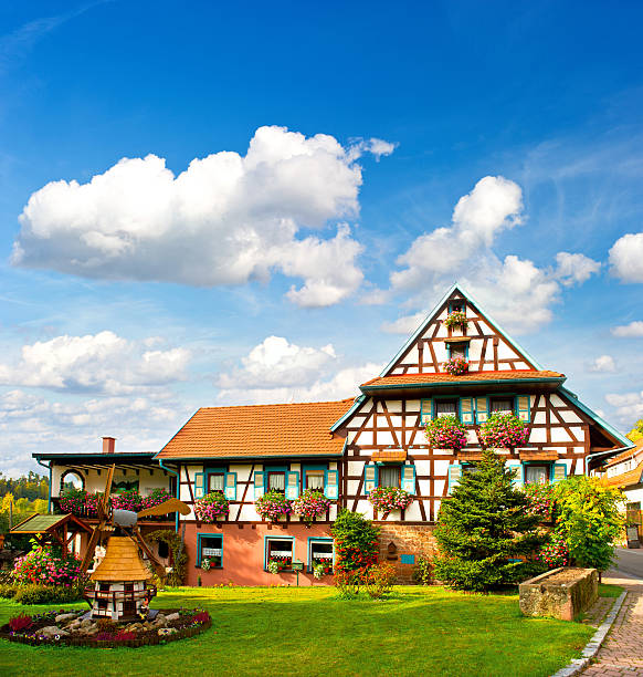 typical traditional house in the Black Forest, Germany typical traditional house in the Black Forest, Southern Germany. european landscape with flowers garden and cloudy blue sky half timbered stock pictures, royalty-free photos & images