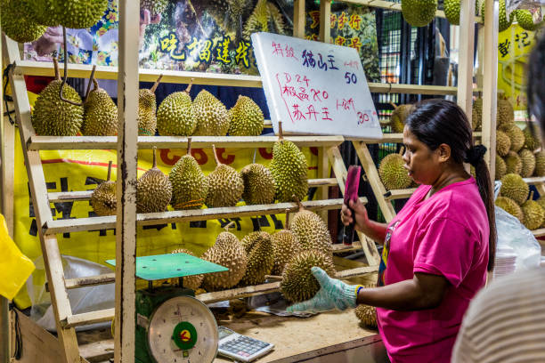 A typical view in Kualur Lumpur Malaysia Luala Lumpur malaysia. March 16 2019. A view of a durian stall at the famous night food market Jalan Alor in Kuala Lumpur in Malaysia bukit bintang stock pictures, royalty-free photos & images