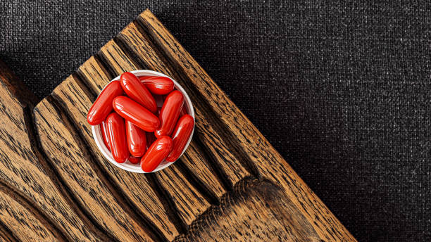 ubiquinol supplement softgels on a wooden desk. dietary supplements top view. mental wellbeing and personal health concept stock photo