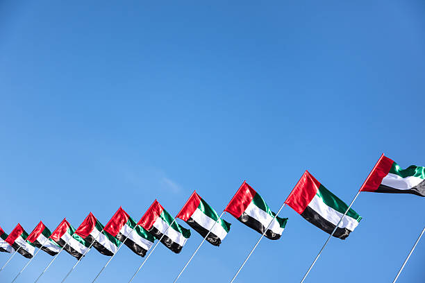uea national flag waving on the sky uea national flag waving on the sky united arab emirates flag stock pictures, royalty-free photos & images