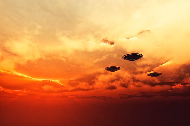 UFOs flying at sunset stock photo