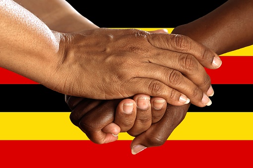 uganda flag, intergration of a multicultural group of young people.