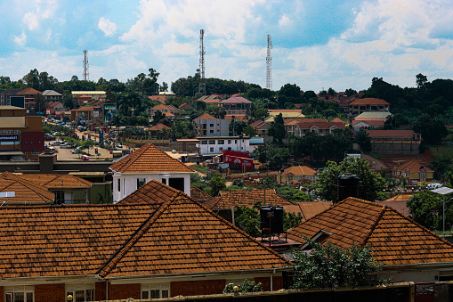 Ugandan skyline, orange rooves, residential area, trees, three radio towers, blue sky, view of main road, Naalya, Kampala